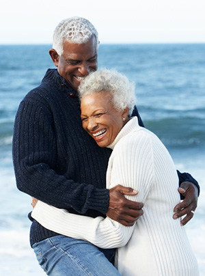 Romantic Senior Couple Hugging On Beach